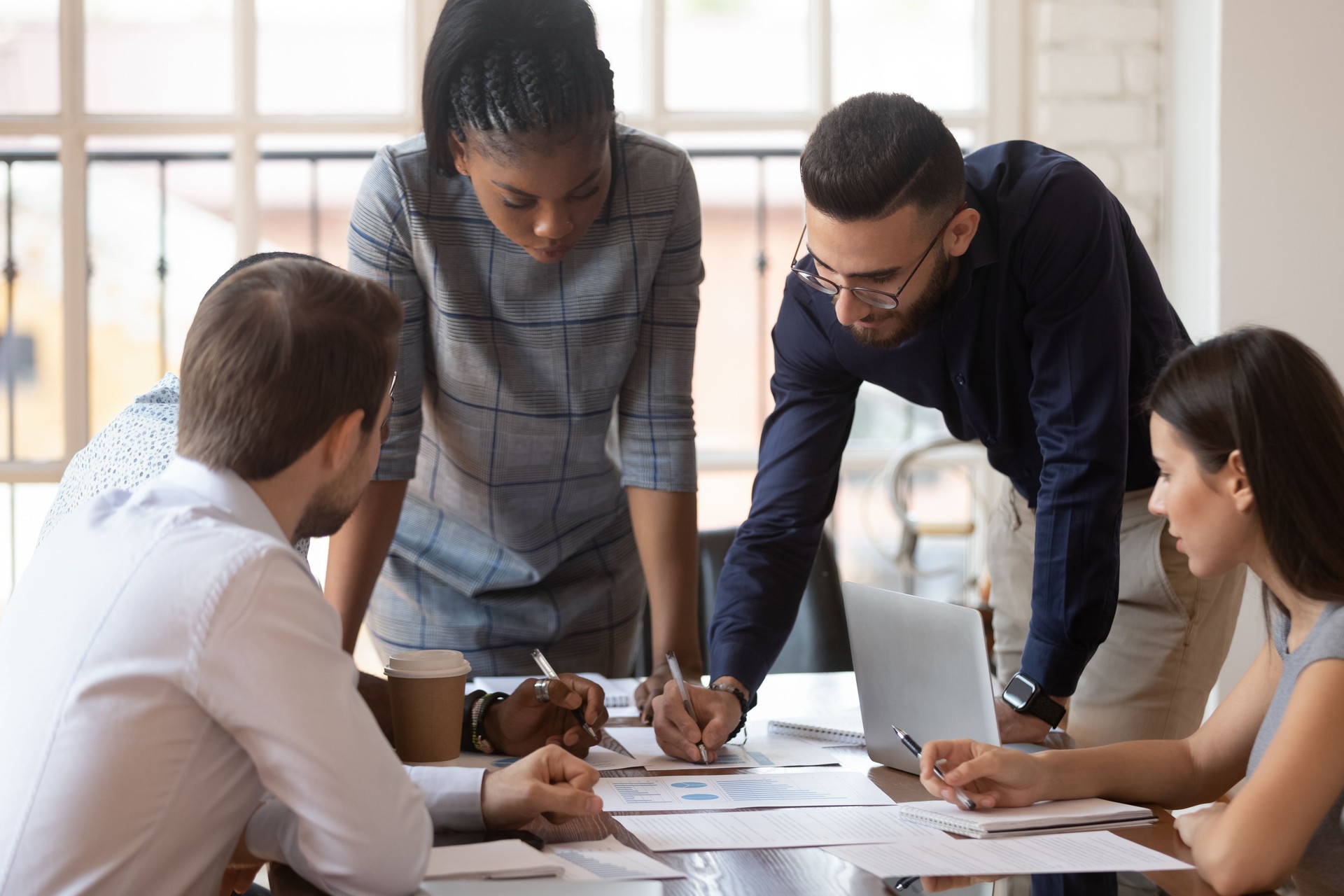 Les gens multiraciaux concentrés d'équipe d'affaires d'entreprise remue-méninges sur la paperasserie